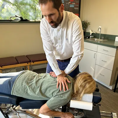 Chiropractor Kenosha WI Kellen Binder Adjusting Patient