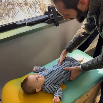 Chiropractor Kenosha WI Kellen Binder Adjusting Pediatric Patient
